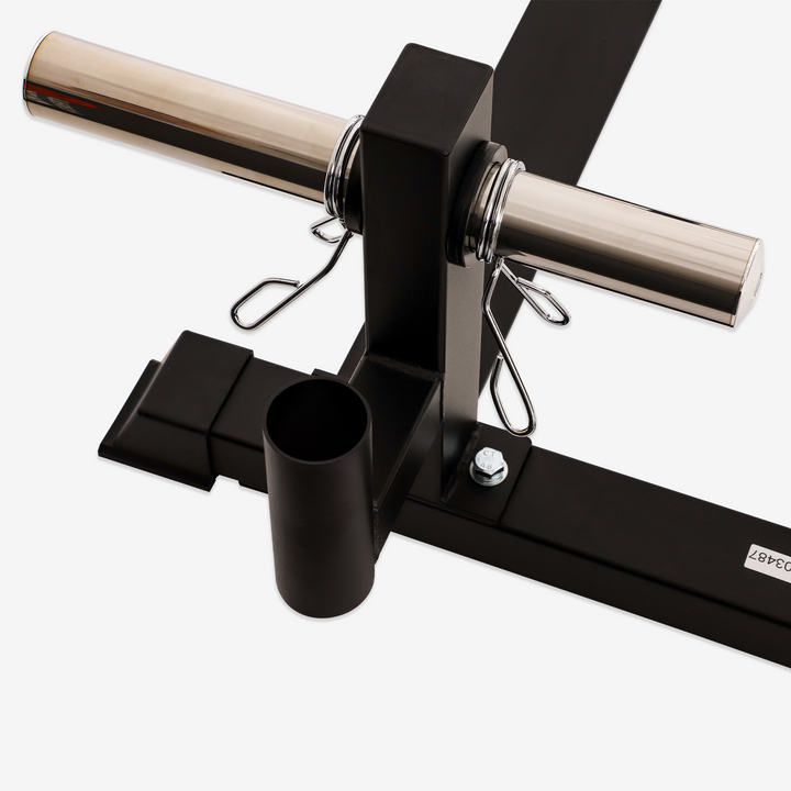 Black exercise machine with metal bar on a white background