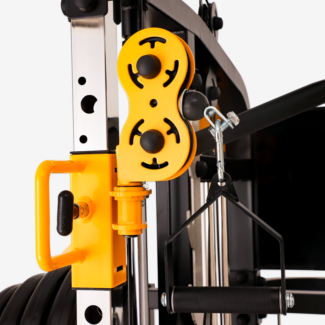 Close-up of a yellow pulley system on a gym machine.