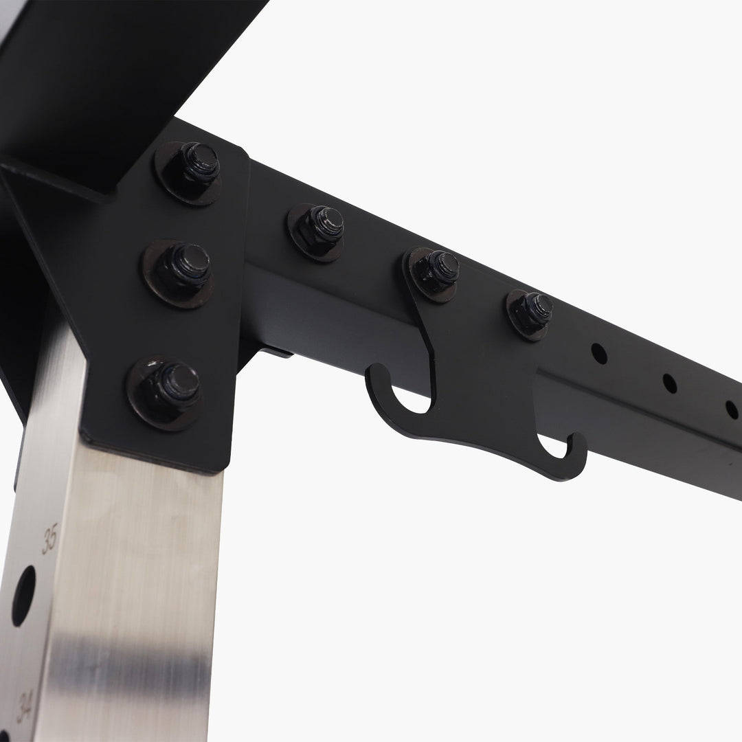 Close-up of a folding knife with a black handle and metallic blade on a white background