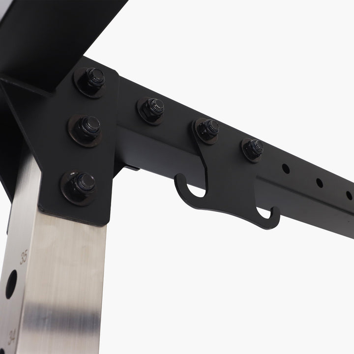 Close-up of a folding knife with a black handle and metallic blade on a white background