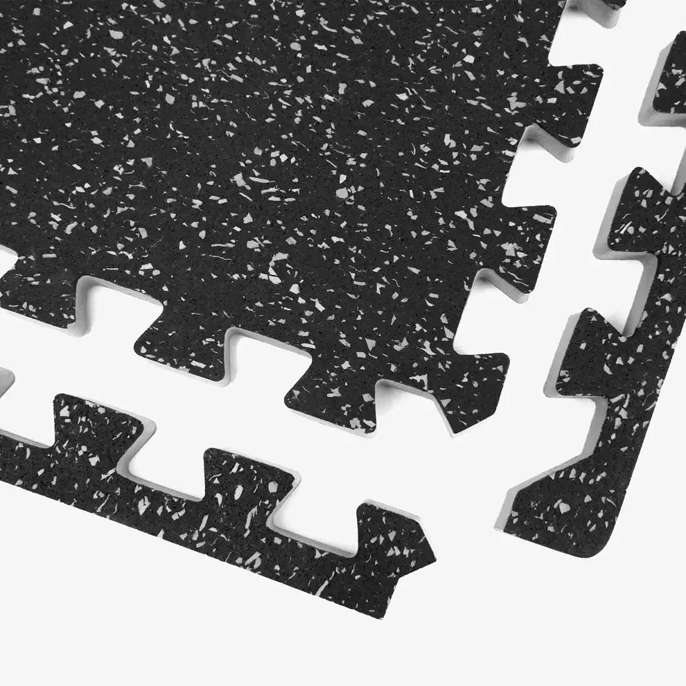Interlocking rubber mat close-up, featuring a non-slip surface ideal for gym equipment like treadmills and weights.