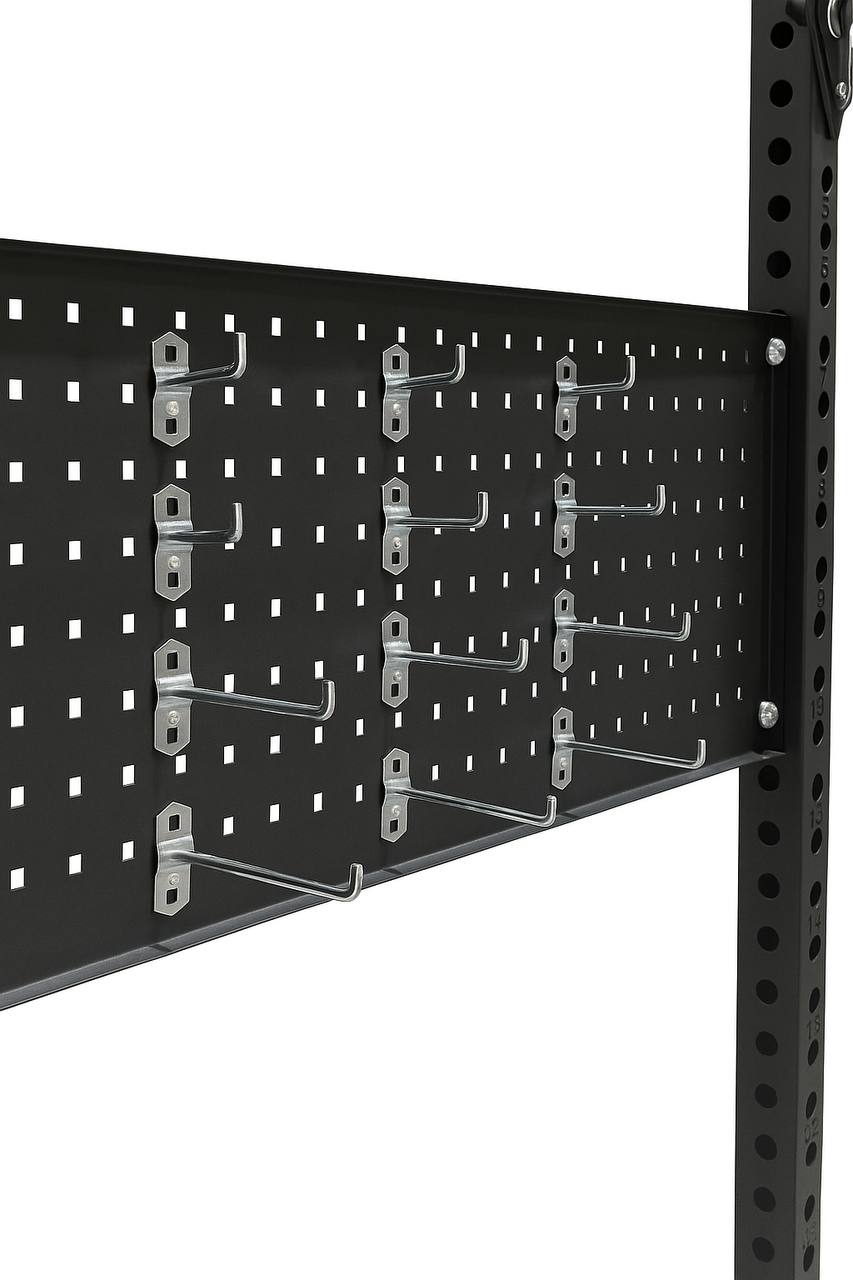 Close-up of black pegboard with metal hooks for organizing gym equipment and accessories.