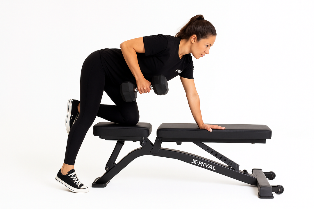 Woman using X-RIVAL Rubber Hex Dumbbell on an adjustable bench for strength training.